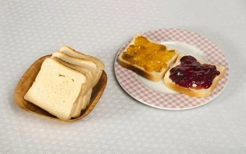 Spread jam on bread Spread jam on bread. Pink checkered plate ,model relea... Stock Photos