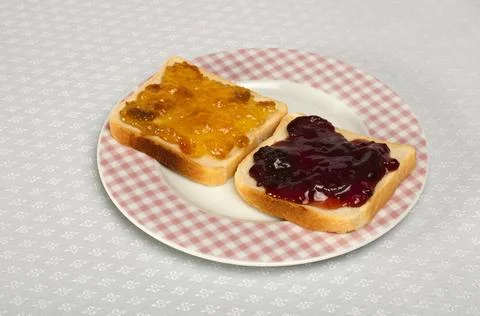 Spread jam on bread Spread jam on bread. Pink checkered plate ,model relea... Stock Photos