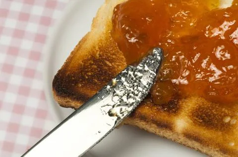 Spread jam on bread Spread jam on bread with knife ,model released, Symbol... Stock Photos