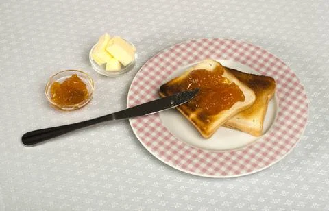 Spread jam on bread Spread jam on bread with knife ,model released, Symbol... Stock Photos