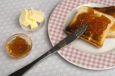 Spread jam on bread Spread jam on bread with knife ,model released, Symbol... Stock Photos