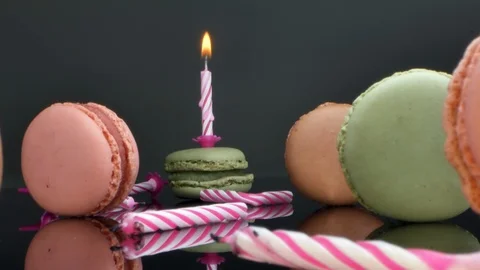 Spread macaroons and a burning candle for the holiday Stock Footage 125376258