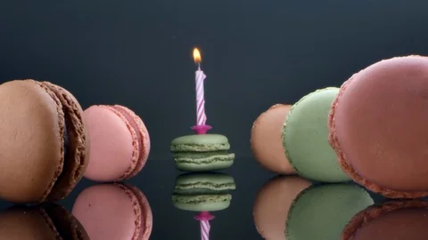 Spread macaroons and a burning candle for the holiday Stock Footage 125376556