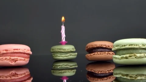 Spread macaroons and a burning candle for the holiday Stock Footage 125377280