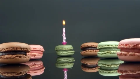 Spread macaroons and a burning candle for the holiday Stock Footage 125403073