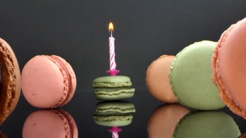 Spread macaroons and a burning candle for the holiday Stock Footage 125500595