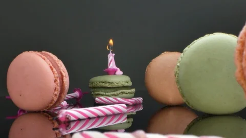 Spread macaroons and a burning candle for the holiday Stock Footage 125501480