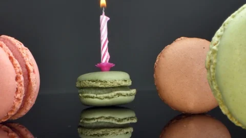 Spread macaroons and a burning candle for the holiday Stock Footage 125537132
