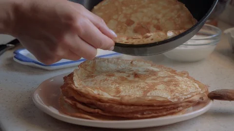 Spread pancake from the pan in a plate. Stock Footage 112912714