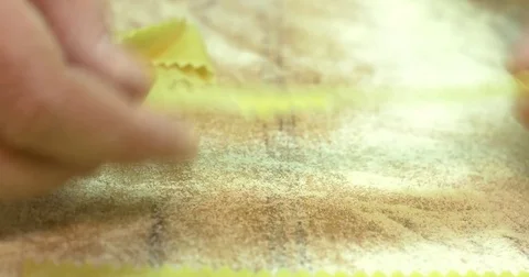 Spread in a row thinly sliced pasta macaroni with a wavy edge timelapse, close Stock Footage 74718563