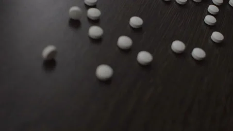 Spread the tablets on the table. White round tablets. Stock Footage 95554294