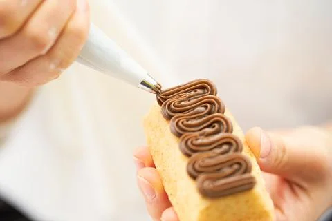 Spread whipped cream on bread Stock Photos