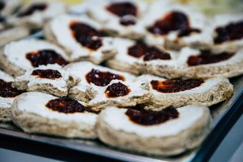 Spreadable cheese with jam on bread bites Stock Photos