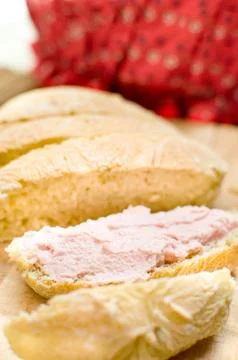 Spreadable mortadella bologna pink mousse on bread slices Stock Photos