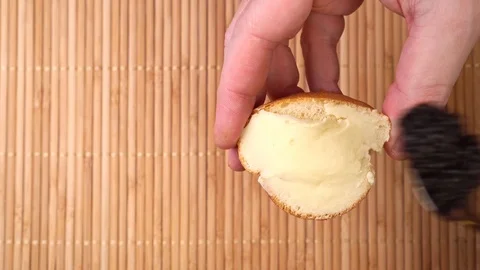 Spreading black caviar on bread and butter. cooking apitizers Stock Footage 122311216