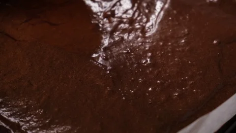 Spreading brownie batter on the tray by scraper Stock Footage 123244338