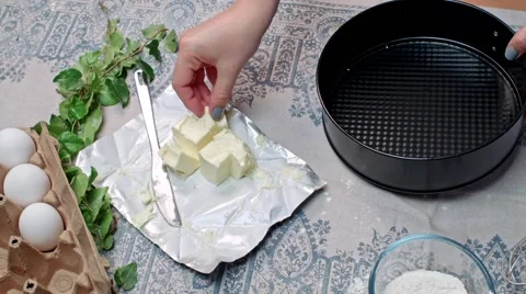 Spreading butter on baking pan Stock Footage 68017633