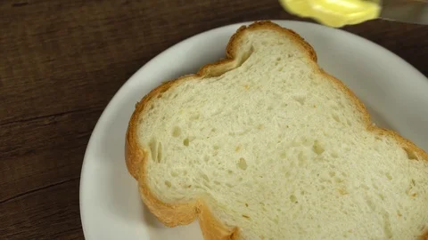 Spreading butter on bread, closeup Stock Footage 113074182