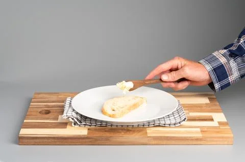 Spreading Butter on Bread Slice Foto stock