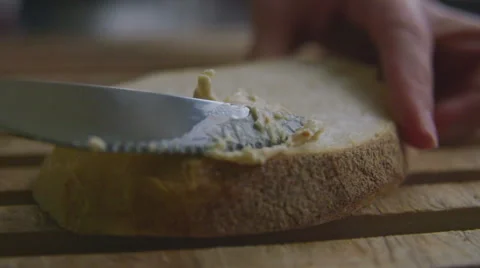 Spreading butter on bread, slow motion Stock Footage 57638924