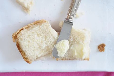 Spreading butter on bread, top view Stock Photos