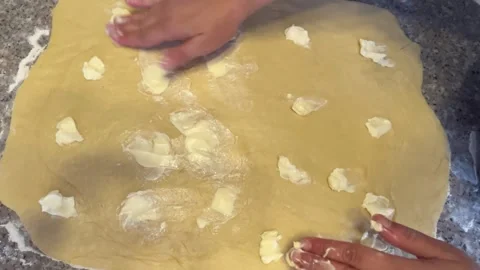 Spreading Butter Over Rolled Dough by Hand for Pastry Making Stock Footage 345522392