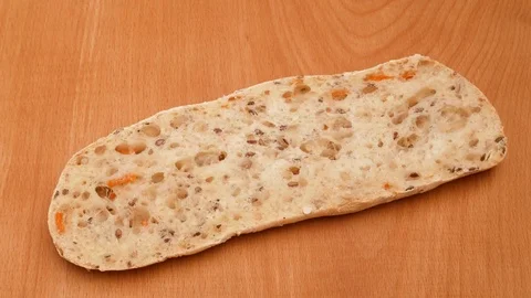 Spreading butter on a piece of wheat bread. Stock Footage 71979082