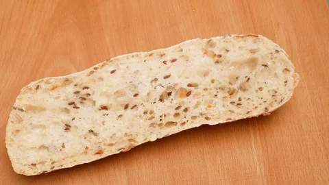 Spreading butter on a piece of wheat bread. Stock Footage 71979103