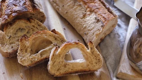 Spreading butter on a piece of wheat bread, close up Stock Footage 73776566