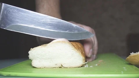 Spreading butter on a piece of wheat bread, close up Stock Footage 99571774