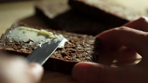 Spreading butter on rye bread, close-up. Healthy vegan breakfast without da.. Stock Footage 289076922
