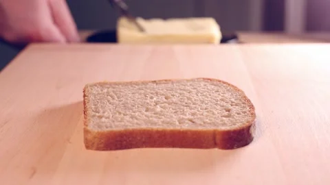 Spreading butter on a slice of bread.  Stock Footage 146276598