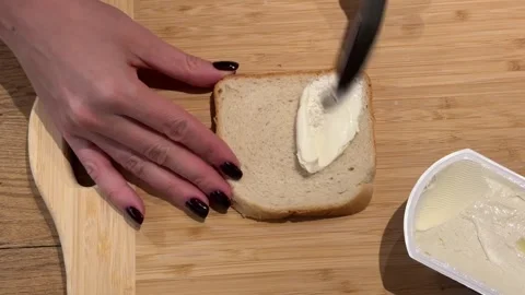 Spreading Butter on a Slice of Toast Bread Stock Footage 328059708