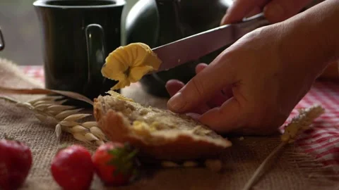 Spreading butter on slice of wholemeal bread Stock Footage 160852005