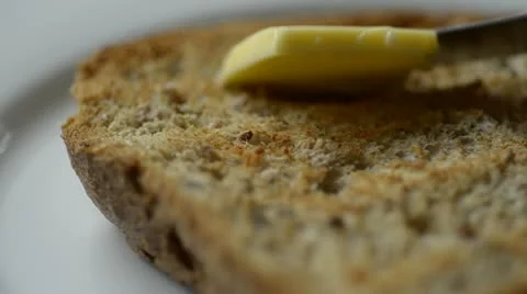 Spreading butter on toast Stock Footage 12591884
