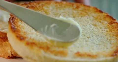 Spreading butter on toast Stock Footage 99734632
