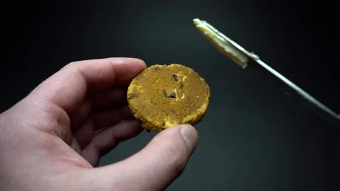 Spreading butter on a whole wheat cookie for breakfast with a knife. Close up. Stock Footage 85642883