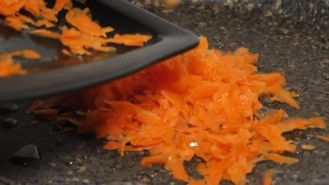 Spreading Carrots onto the Frying Pan Stock Footage 311391102