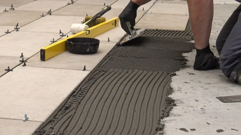 Spreading cement adhesive on the floor Stock Footage 111866558
