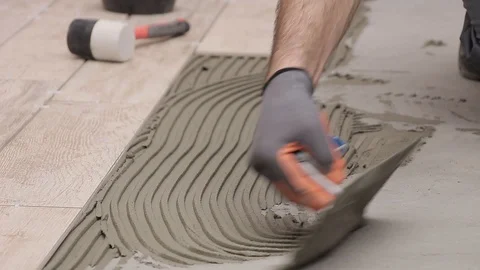 Spreading cement adhesive Stock Footage 111865145