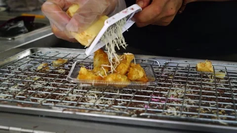 Spreading cheese on fried banana while still hot Stock Footage 146130198