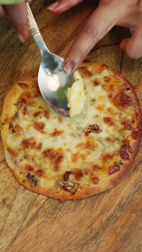 Spreading cheese on a pizza. making cheese pizza. cheese spreading on pizza. Stock Footage 283362403