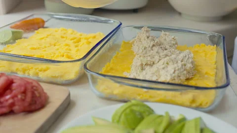 Spreading Chicken Layer for Traditional Peruvian Causa Limeña Assembly Stock Footage 338340946