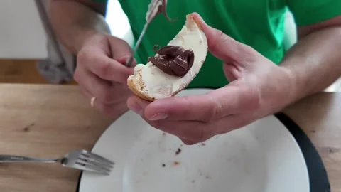 Spreading Chocolate Cream on Bread with Knife Stock Footage 311041446