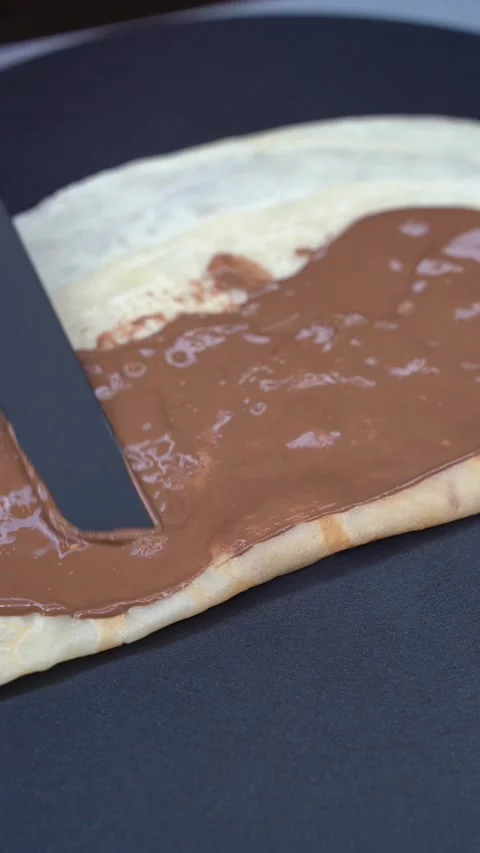 Spreading Chocolate on a Fresh Crepe Stock-Footage 336853339