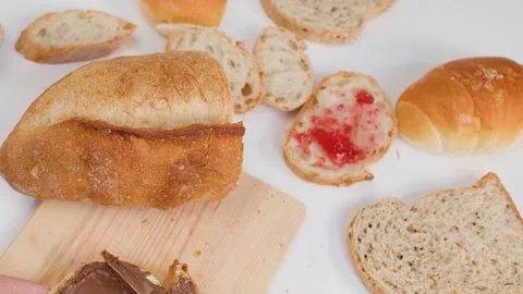 Spreading Chocolate Hazelnut Cream on Fresh Sourdough Bread Slice Stock Footage 337519024