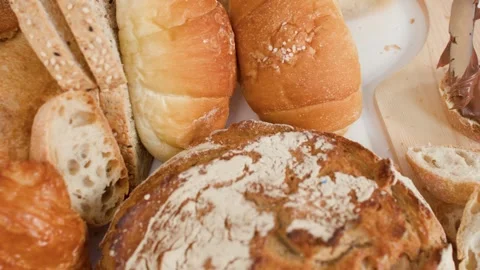 Spreading Chocolate Hazelnut Cream on Fresh Bread in a Bakery Stock Footage 338377461