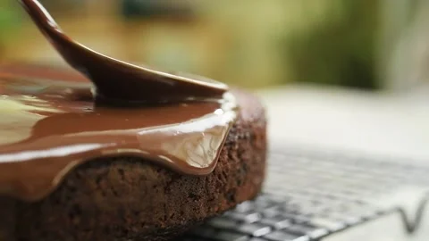 Spreading chocolate icing over the cake. Stock Footage 207020504