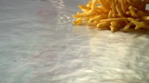 Spreading cooked chips out on a baking tray Stock Footage 8571809