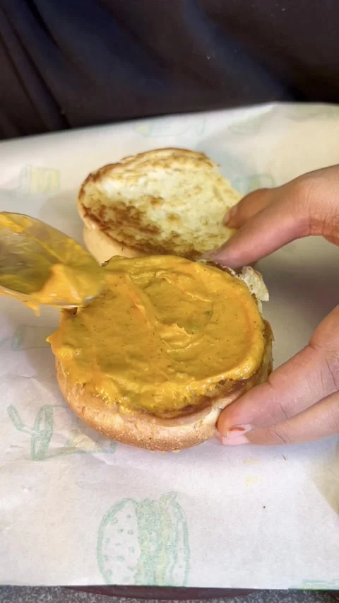 Spreading cream on a bread for making tikki. Stock Footage 287176630